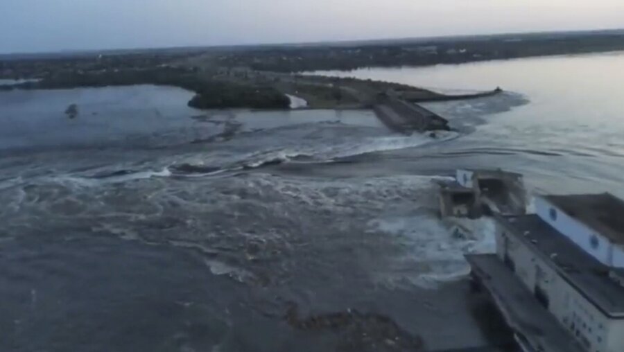 Ein vom ukrainischen Präsidialamt veröffentlichtes Videostandbild zeigt Wasser, das durch einen Durchbruch im Kachowka-Staudamm fließt / © Uncredited/Ukrainian Presidential Office/AP  (dpa)