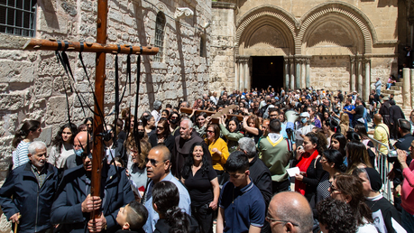 Die Lateinische Pfarrei von Jerusalem, begleitet von Pfadfindern und Polizeibeamten, gehen mit zwei großen Holzkreuzen den Kreuzweg, die Via Dolorosa, in Jerusalem an Karfreitag am 15. April 2022. / © Andrea Krogmann (KNA)