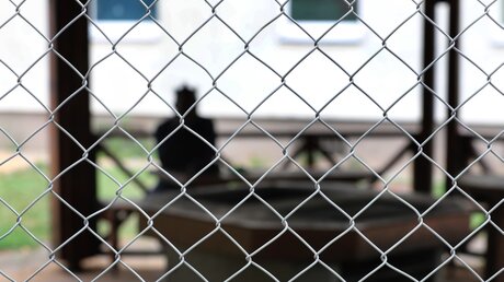 Asylsuchender hinter einem Zaun / © Karl-Josef Hildenbrand (dpa)